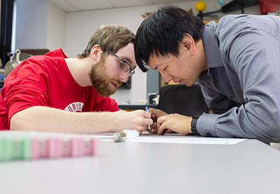 early-assurance-programs A student and teacher analyze data.