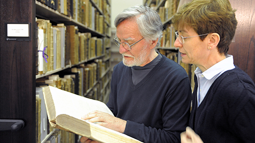 Two scholars studying a centuries-old text